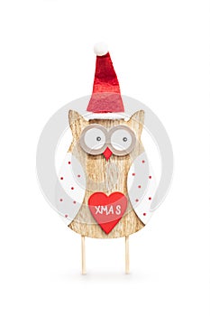 Cute wooden Christmas owl with Santa hat, red heart on its belly and inscription Xmas. Isolated on white background with