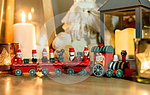 Cute wooden train and lantern at home. Merry Christmas and Happy New Year greeting card