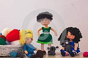 Cute wool dolls are lying on the table