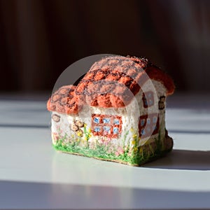 Cute woolly toy house with flowers, felting wool