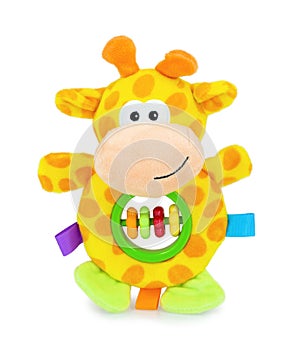 Cute yellow giraffe rattle doll with plastic rings isolated on white background with shadow reflection. Playful colorful giraffe