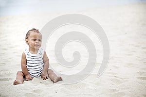 Cute you boy playing in the sand on the beach