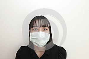 Cute young asian woman wearing protective face mask to protect from epidemic and virus