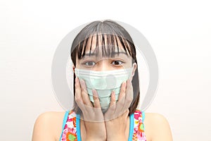 Cute young asian woman wearing protective face mask to protect from epidemic and virus