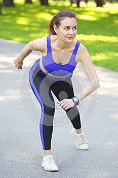 Cute young athletic girl doing sports in nature