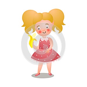 Cute young blonde girl in polka red dress eating yellow banana