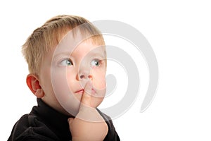 Cute young boy with blonde hair looking up