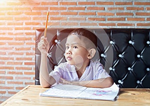 Cute young boy doing homework