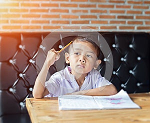 Cute young boy doing homework