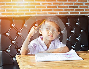 Cute young boy doing homework