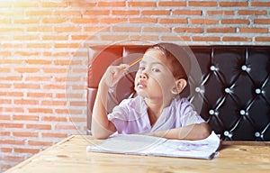 Cute young boy doing homework