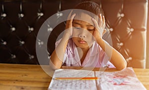Cute young boy doing homework