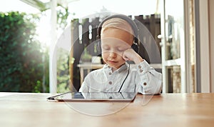 Cute young boy immersed in his music photo