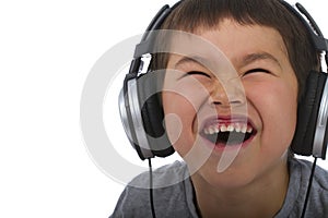 cute young boy listening to music and laughing