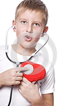 Cute young boy playing doctor