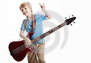 Cute young boy playing an electric guitar