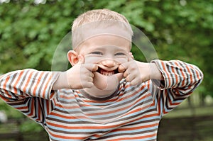 Cute young boy pulling a funny expression