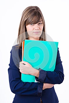 Cute young business woman in a jacket with a green and orange folders in hands looking direct forward