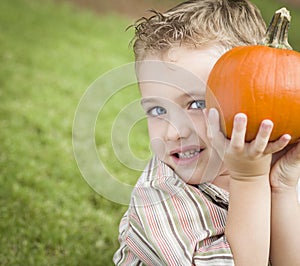 Cute Young Child Boy Enjoying the Pumpkin Patch.