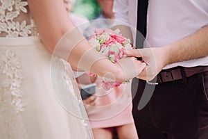Cute young couple bride and groom is holding their hands