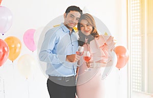 Cute young couple, Caucasian man with an Asian woman. Celebrate the New Year festival and look at the camera. Holding hands at a