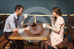 Cute couple drinking tea outdoors