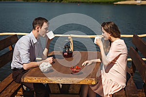 Cute couple drinking tea outdoors