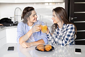 Cute young couple enjoying their breakfast together in the kitchen