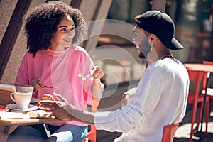 Cute young couple having coffee in the cafe