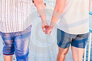 Cute young couple in love is holding their hands and walking together