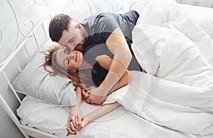 Cute young couple lying down on the bed and sleeping together