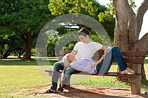 Cute young couple relaxing on bench.