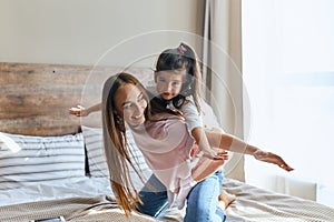 Cute young daughter on a piggyback ride