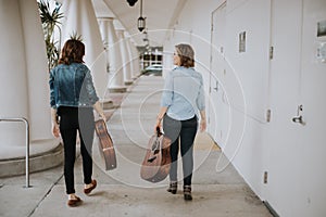 Cute Young Female Musician Friends Modeling in an Outdoor Hallway Corridor