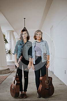 Cute Young Female Musician Friends Modeling in an Outdoor Hallway Corridor