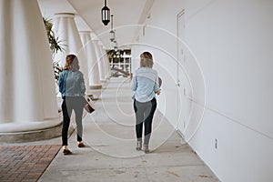 Cute Young Female Musician Friends Modeling in an Outdoor Hallway Corridor