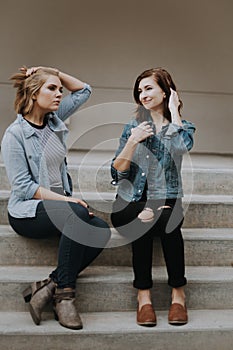 Cute Young Female Musician Friends Modeling Outside on Concrete Steps