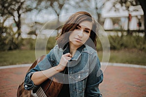 Cute Young Female Musician Modeling and Smiling for the Camera Outside