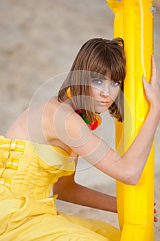 Cute young girl in fashion yellow dress