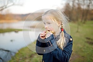 Cute young girl having fun on beautiful spring day. Active family leisure with kids