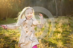 Cute young girl having fun on beautiful spring day. Active family leisure with kids. Family fun outdoors