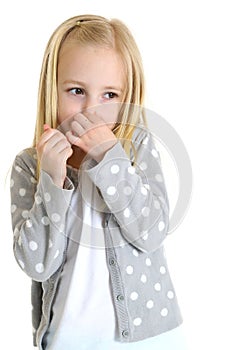 Cute young girl holding her nose from a bad smell