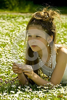 Cute young girl picking flowers