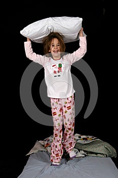 Cute young girl with pillow on her head