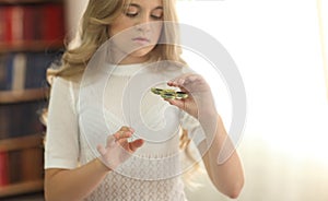 Cute young girl playing with green fidget spinner