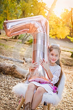 Sweet Young Girl With Number Seven Mylar Balloon Outdoors photo
