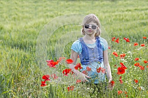 Cute young girl in poppy field