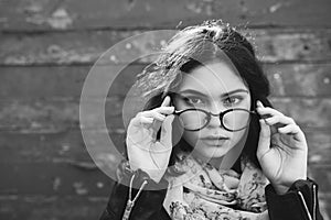 Beautiful happy hipster girl goes in the city. Closeup of trendy girl face.