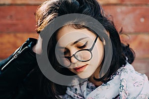 Beautiful happy hipster girl goes in the city. Closeup of trendy girl face.