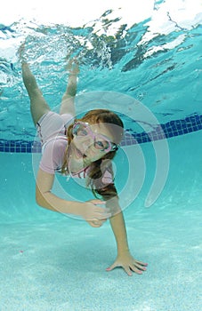 Cute young girl swimming